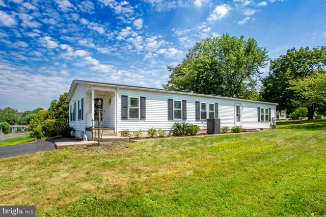 a backyard of a house with yard and outdoor seating