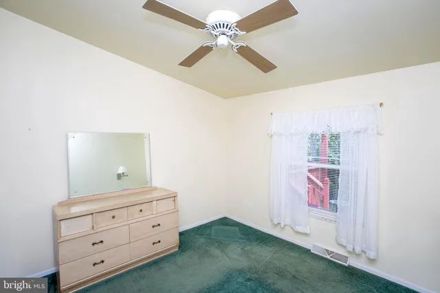 a room with painting on the wall and a potted plant