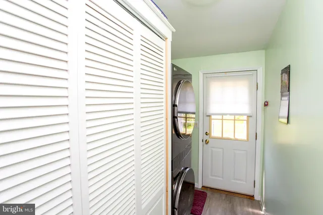 a view of a bedroom with a window and wooden floor