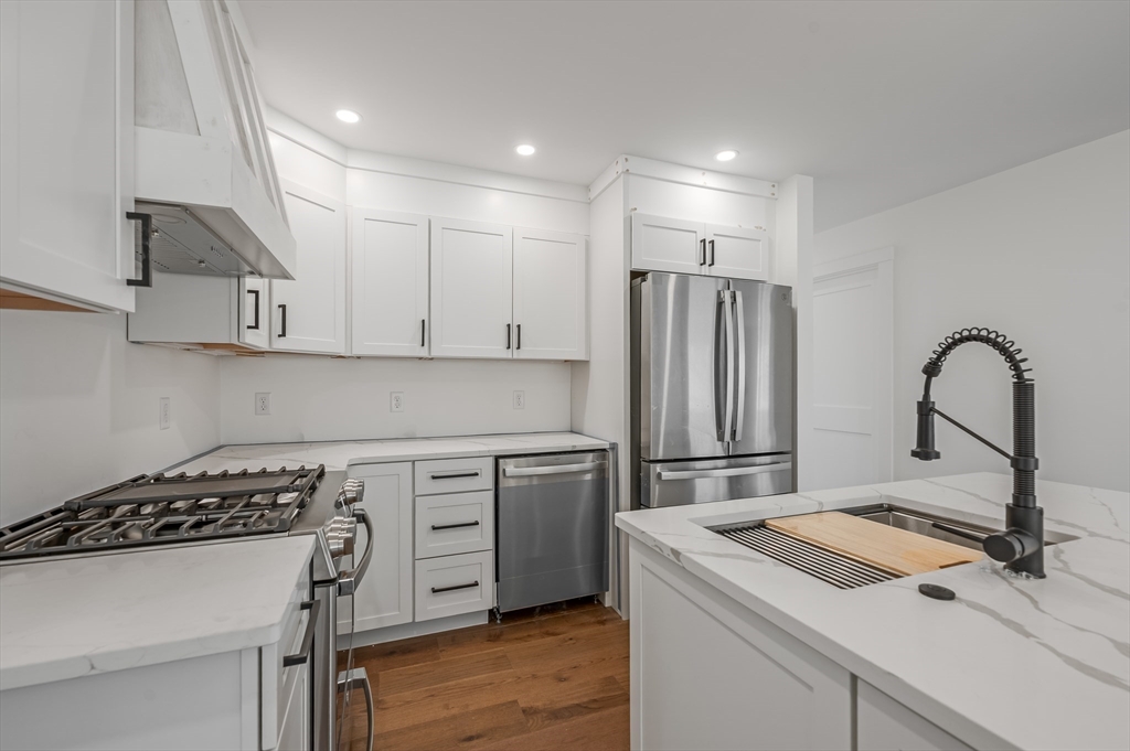 36 Belvidere Road Haverhill, MA 01830 - Photo 1 of 18 a kitchen with a stove a sink and a refrigerator