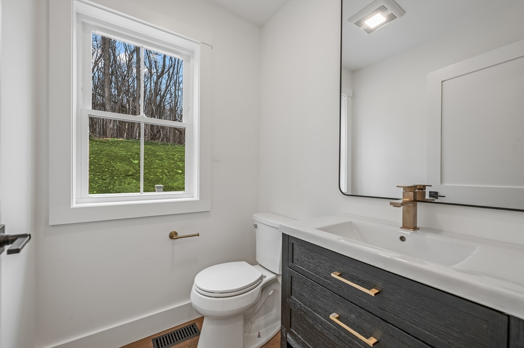 36 Belvidere Road Haverhill, MA 01830 - Photo 13 of 18 a bathroom with a sink a toilet a window and mirror