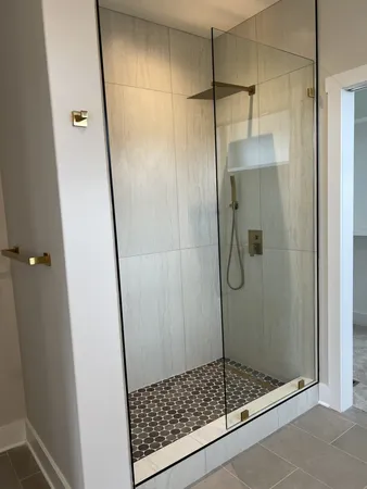 a bathroom with a glass shower door