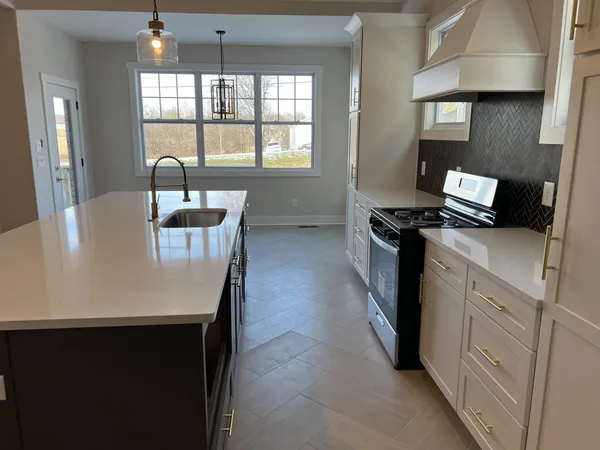 a kitchen with a stove and a refrigerator