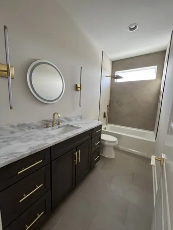 a bathroom with a double vanity sink toilet and a mirror