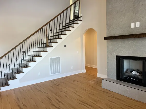 a view of entryway and hall with wooden floor