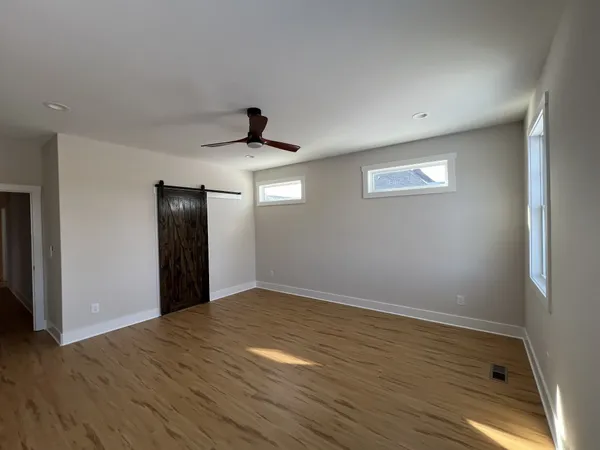 a view of hallway with wooden floor