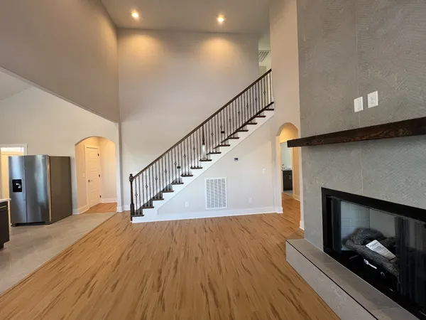 a view of entryway and hall with wooden floor