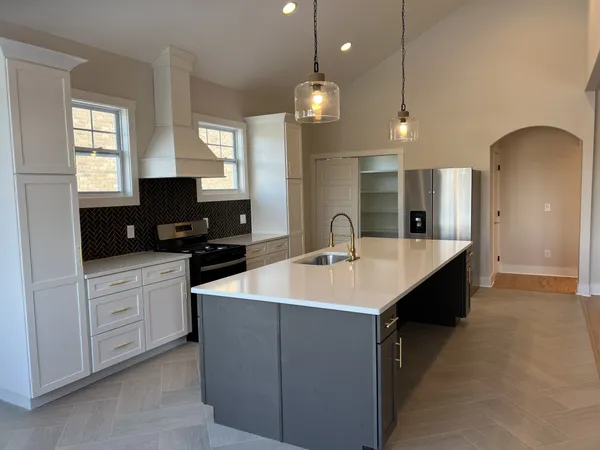 a room with kitchen island a sink a center island and a window
