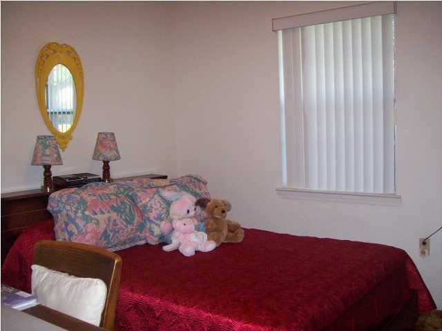 235 Deluna Road Southwest Fort Walton Beach, FL 32548 - Photo 15 of 24 a bedroom with a bed and a painting on the wall
