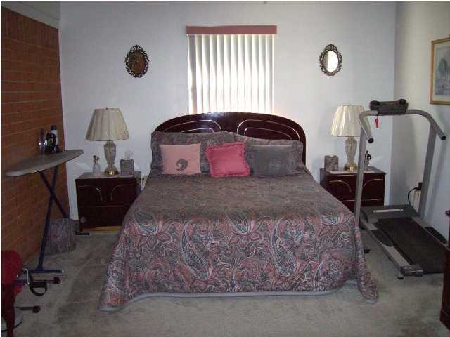 235 Deluna Road Southwest Fort Walton Beach, FL 32548 - Photo 16 of 24 a bedroom with a bed and a lamp
