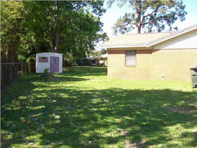235 Deluna Road Southwest Fort Walton Beach, FL 32548 - Photo 21 of 24 a backyard of a house with table and chairs