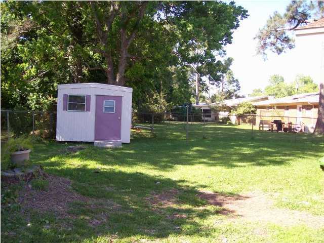 235 Deluna Road Southwest Fort Walton Beach, FL 32548 - Photo 22 of 24 a front view of a house with garden