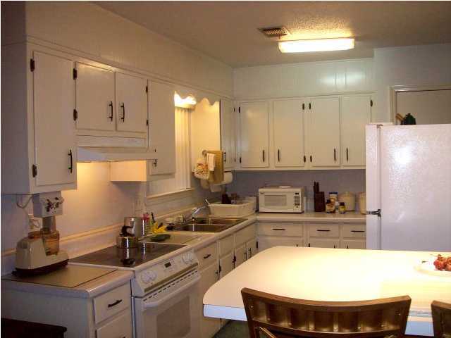 235 Deluna Road Southwest Fort Walton Beach, FL 32548 - Photo 6 of 24 a kitchen with stainless steel appliances a sink a stove a refrigerator and cabinets