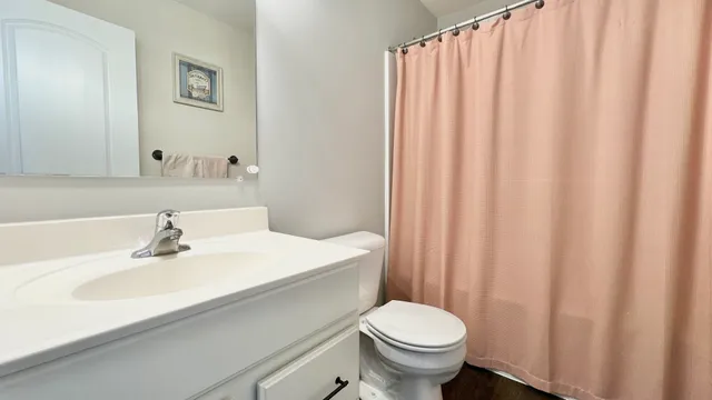 a bathroom with a sink a toilet and a mirror
