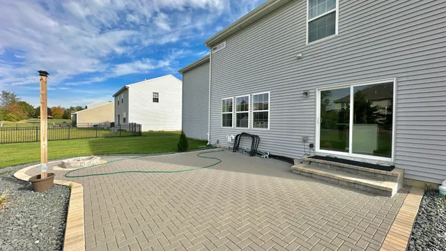 a view of a house with backyard and a tree