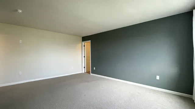 an empty room with a empty space and windows