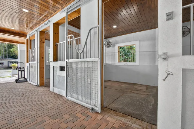 a view of a house with backyard and large trees