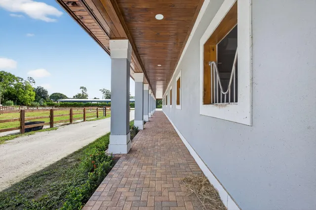 a view of a porch with wooden floor and fence