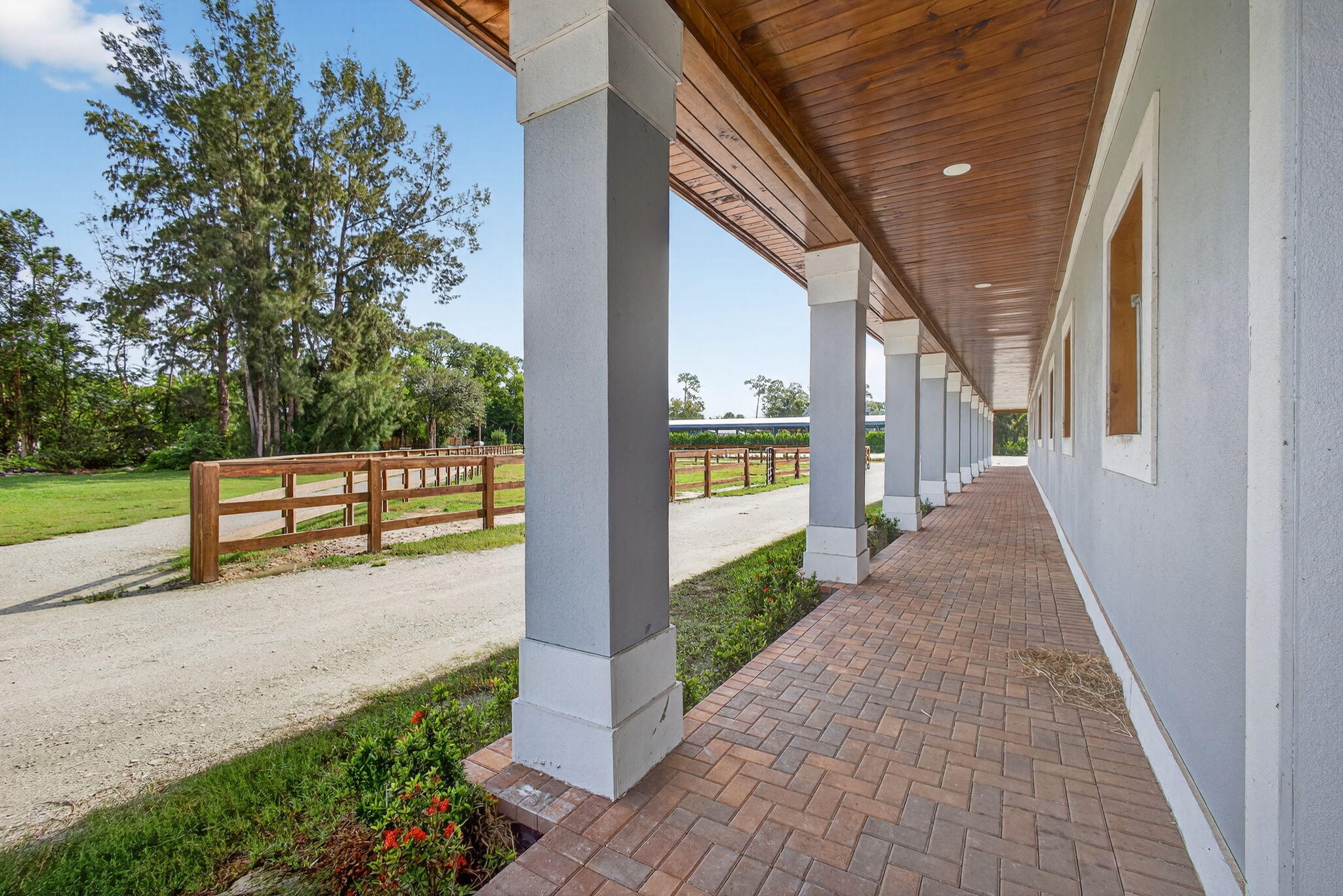 1032 Hyde Park Road Loxahatchee Groves, FL 33470 - Photo 14 of 30 a view of a porch with wooden floor and fence