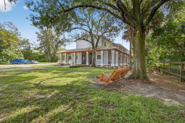 a view of a house with backyard porch and sitting area