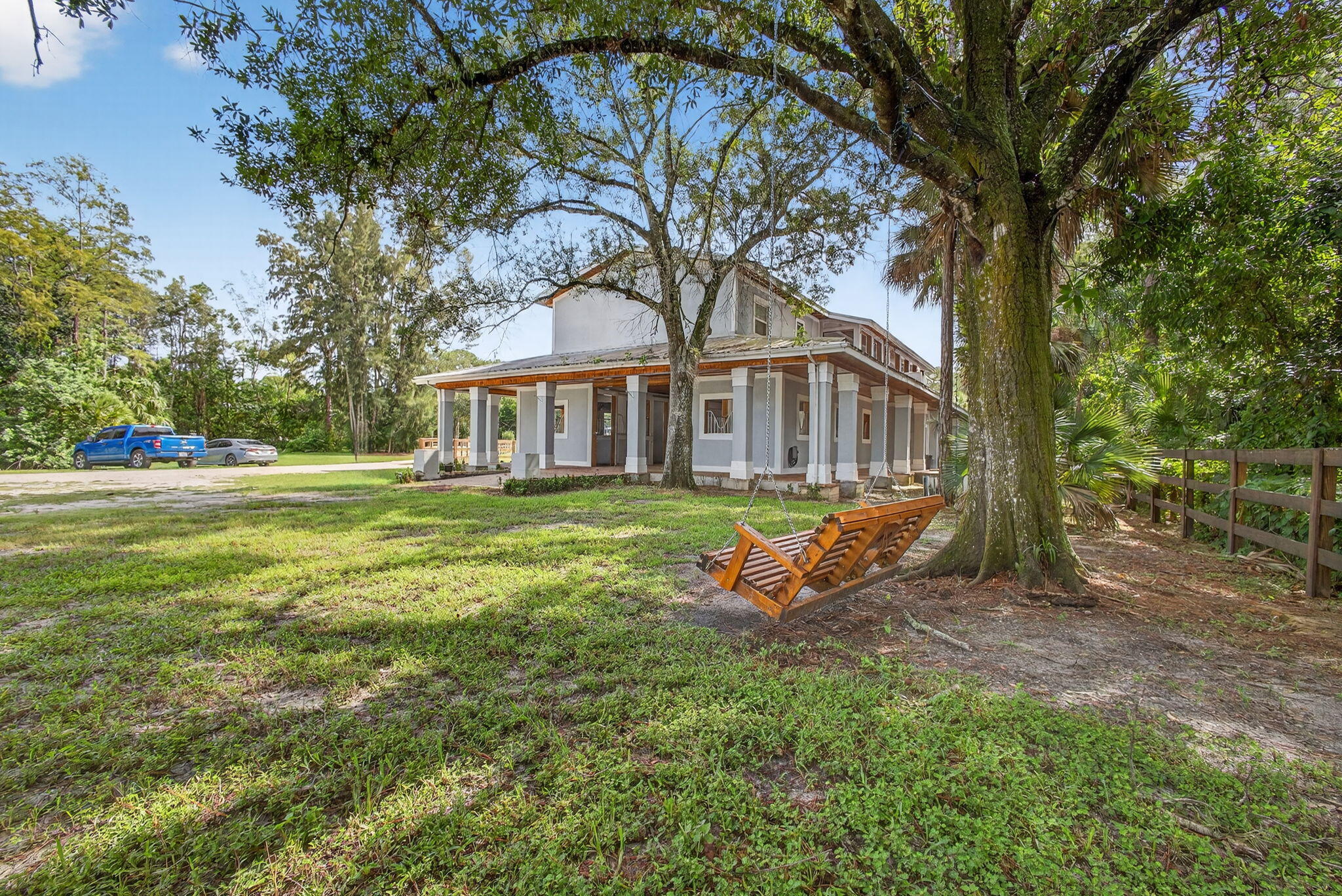 1032 Hyde Park Road Loxahatchee Groves, FL 33470 - Photo 2 of 30 a view of a house with backyard porch and sitting area