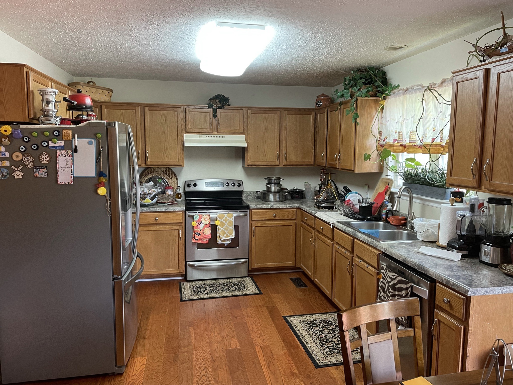721 Canoe Ridge Point Antioch, TN 37013 - Photo 11 of 50 a kitchen with stainless steel appliances a stove refrigerator sink and cabinets