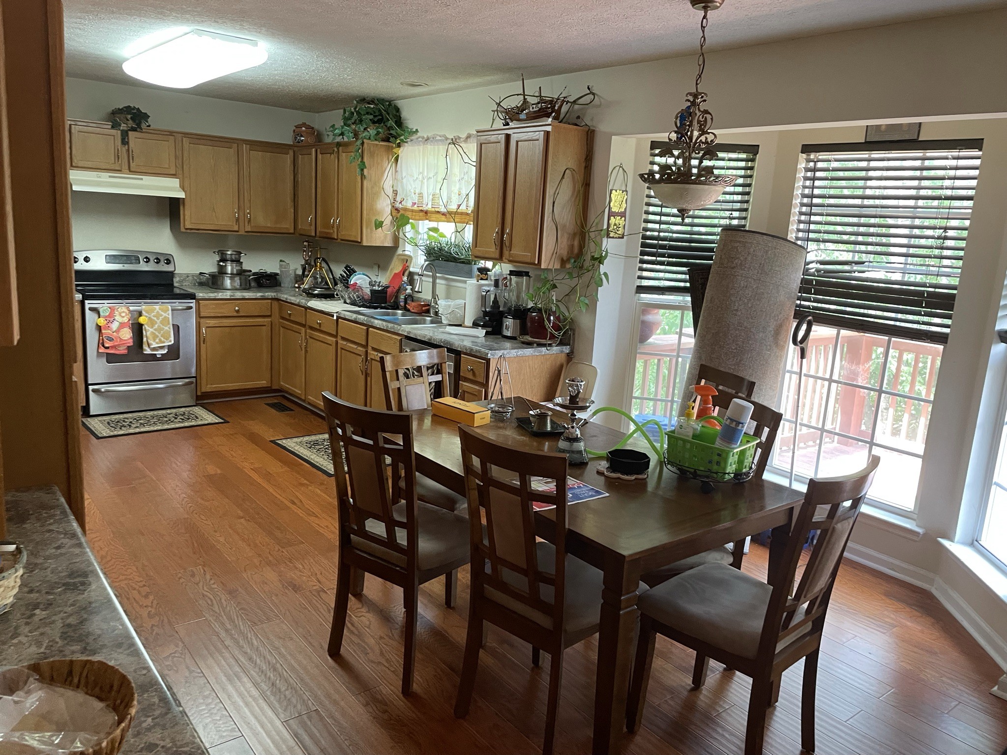 721 Canoe Ridge Point Antioch, TN 37013 - Photo 12 of 50 a kitchen with stainless steel appliances granite countertop a table chairs and a refrigerator