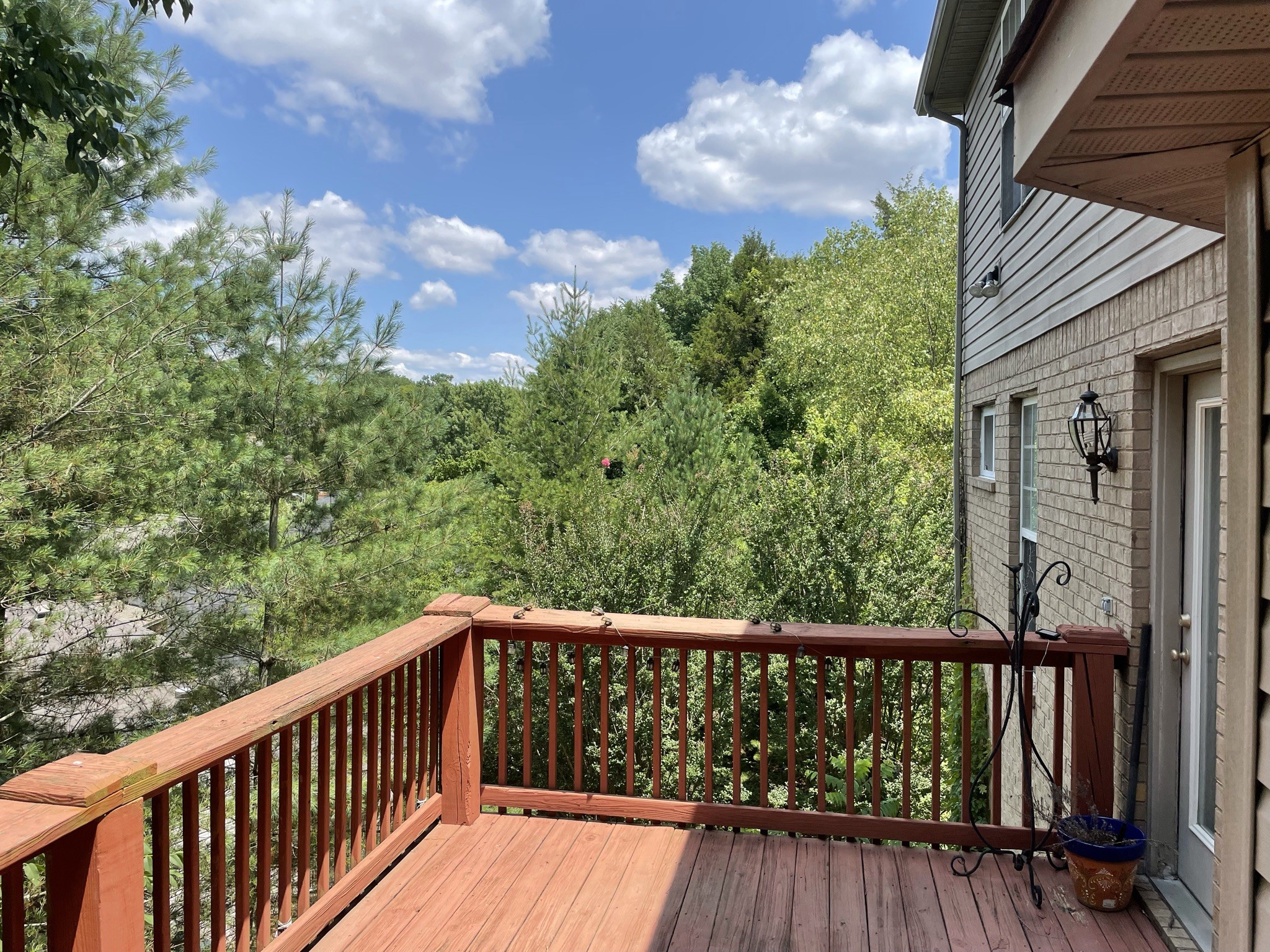 721 Canoe Ridge Point Antioch, TN 37013 - Photo 41 of 50 a balcony with wooden floor and trees in the back