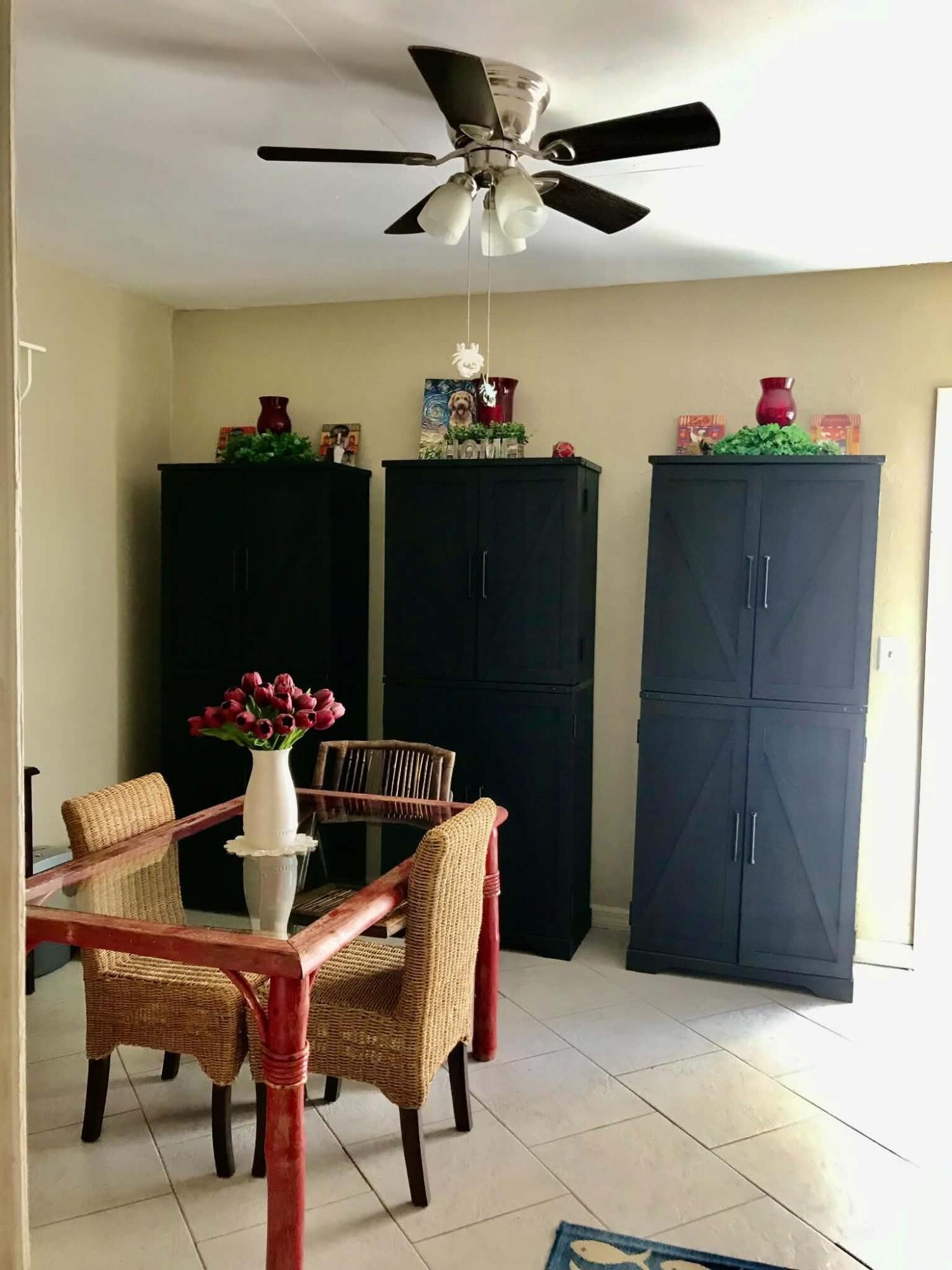 1115 Elm Street Okeechobee, FL 34974 - Photo 17 of 37 a dining room with furniture and chandelier