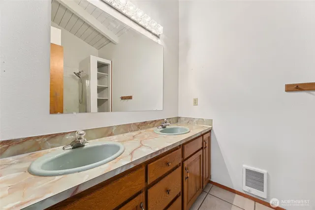 a bathroom with a granite countertop sink and a mirror