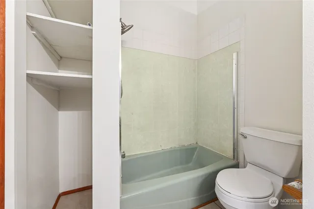 a bathroom with a toilet and a bathtub
