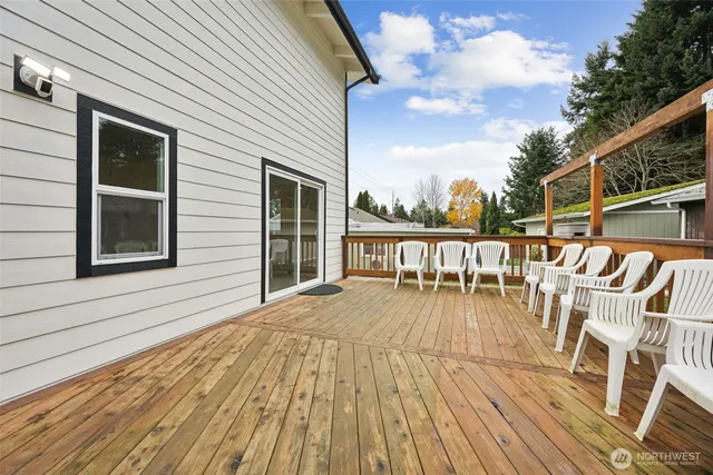 a view of a house with wooden deck