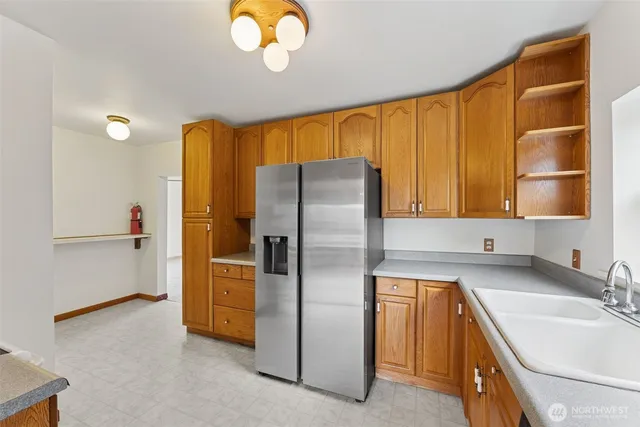 a kitchen with a refrigerator and a sink