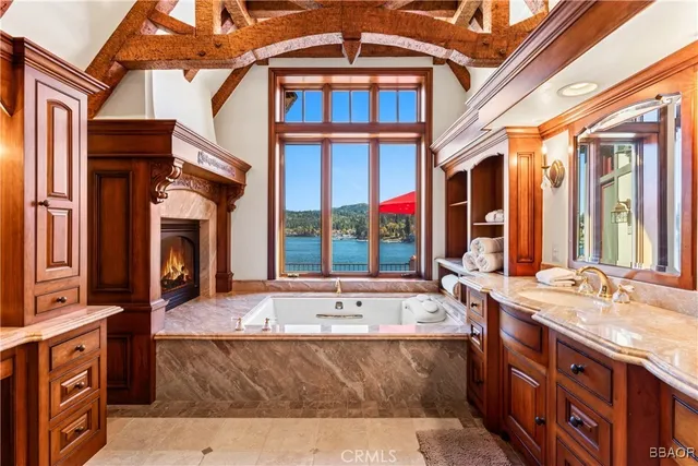 a spacious bathroom with a tub sink and mirror