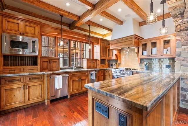 a kitchen with stainless steel appliances granite countertop a stove a sink and a refrigerator