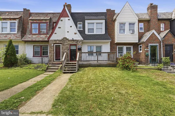 a view of a house with a yard patio and small yard