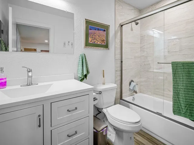 a bed sitting in a spacious bedroom next to a window