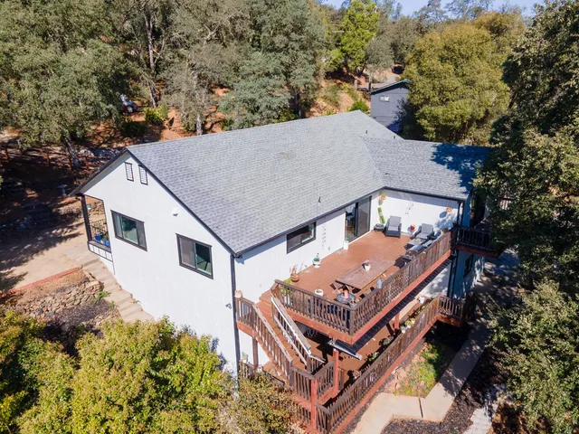 an aerial view of a house with a yard