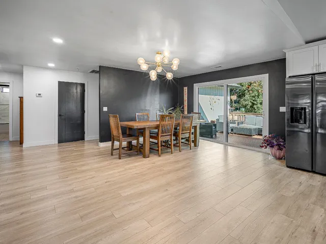 a kitchen with stainless steel appliances granite countertop a refrigerator and a sink