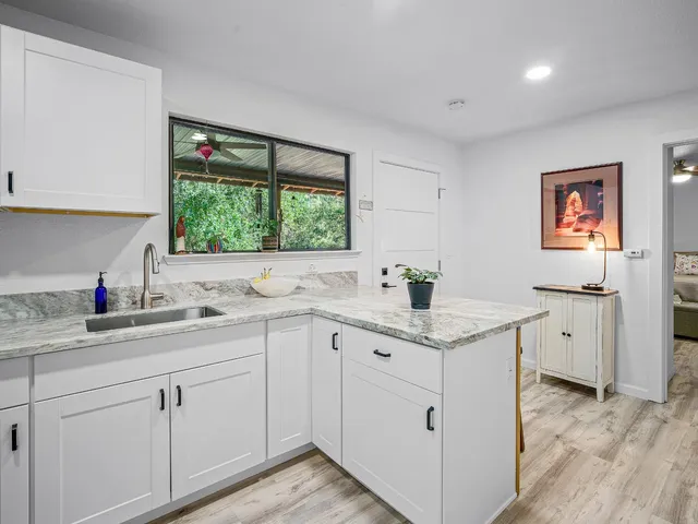 a kitchen with cabinets a sink and appliances