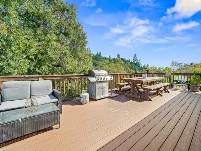 a view of a roof deck with wooden floor and fence