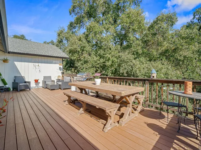 a living room with furniture a rug and a window
