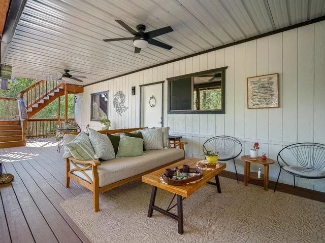 a backyard of a house with table and chairs