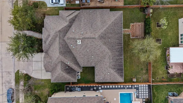 an aerial view of a house with a yard