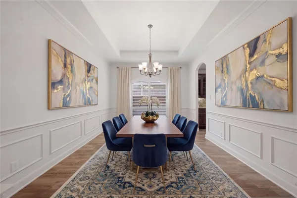a view of a dining room with furniture wooden floor and chandelier
