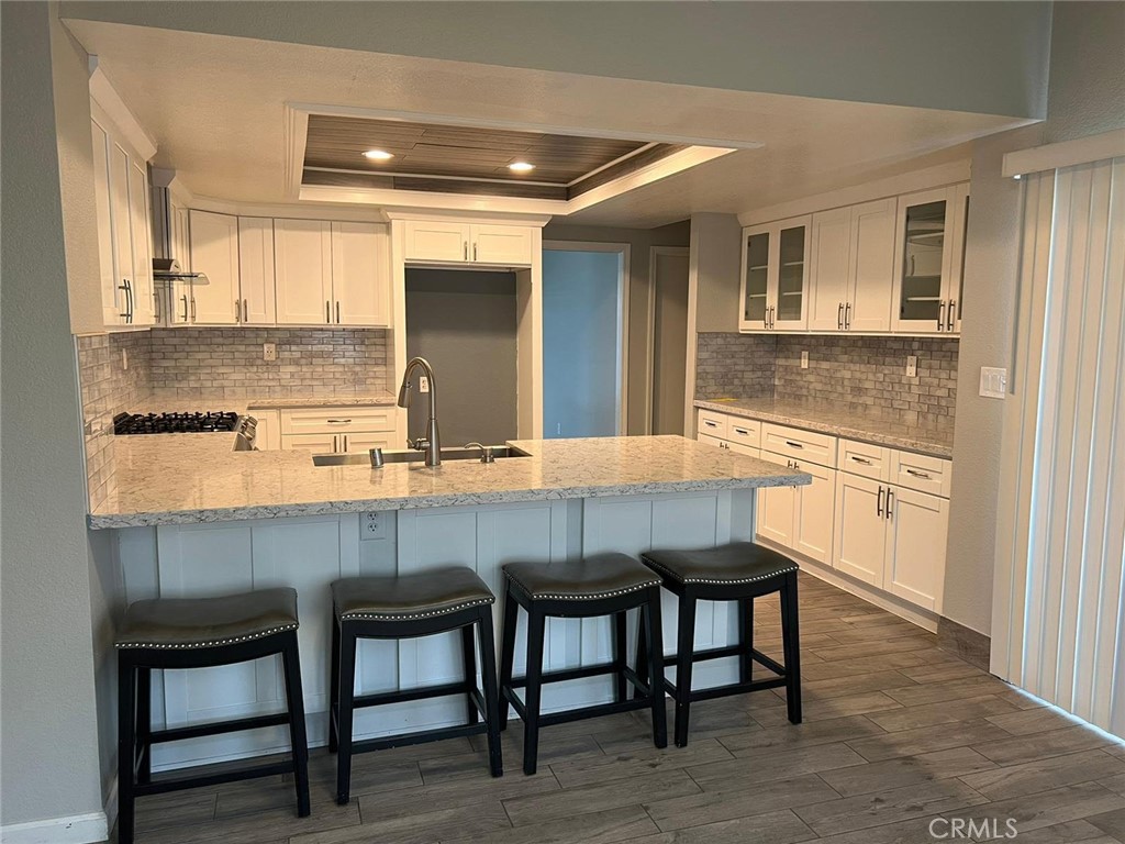 13610 Cuyamaca Road Apple Valley, CA 92308 - Photo 1 of 1 a kitchen with granite countertop a table chairs sink and cabinets