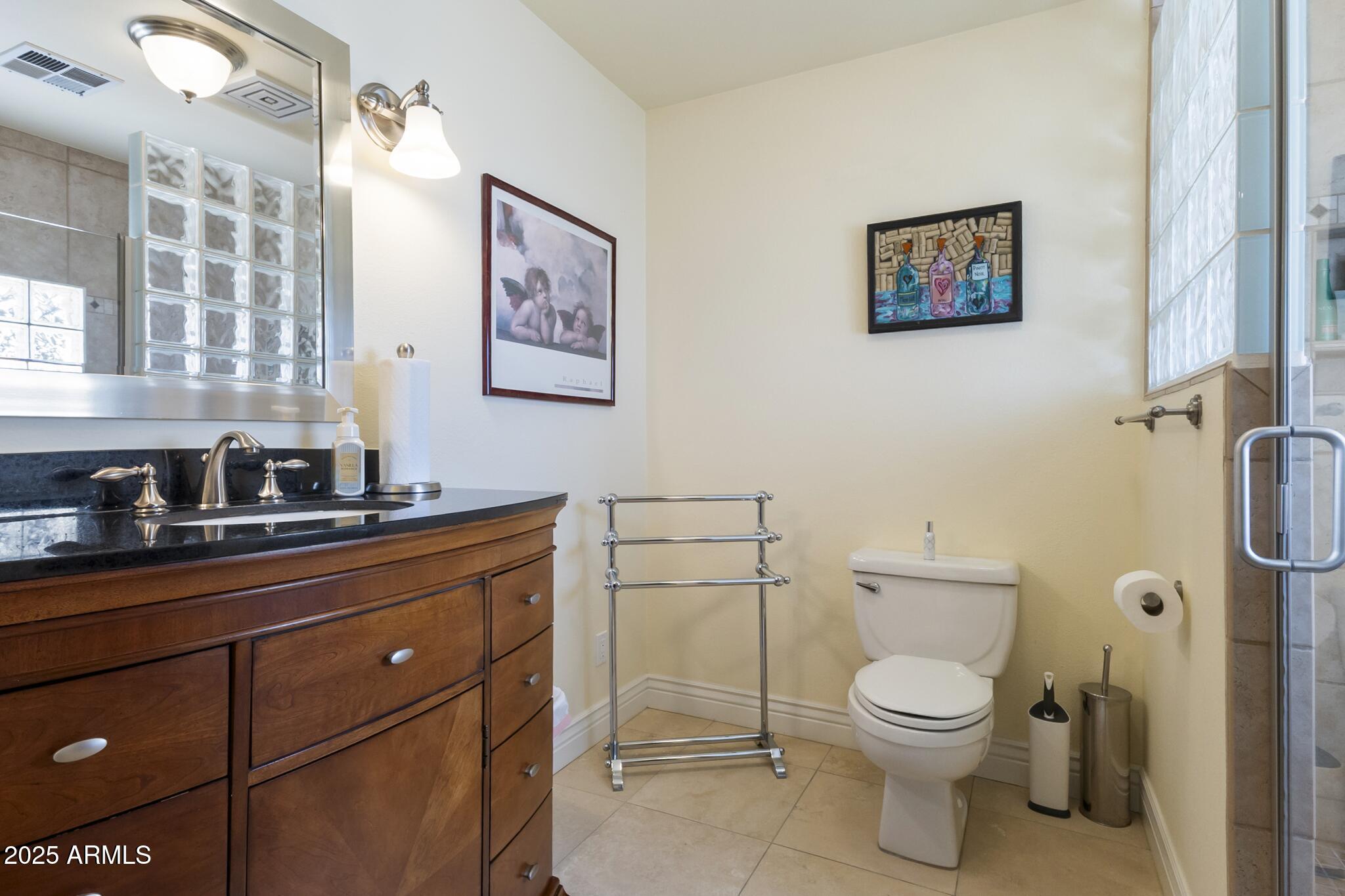 229 West Vista Avenue Phoenix, AZ 85021 - Photo 57 of 113 a bathroom with a toilet a sink and mirror
