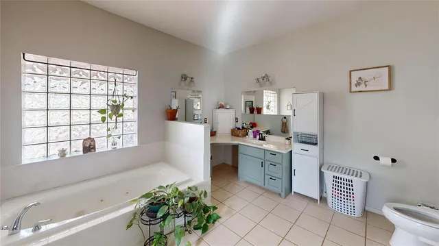 a view of a bedroom with baby crib and toys