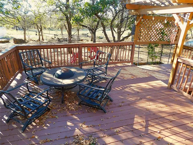 a backyard of a house with barbeque oven and outdoor seating