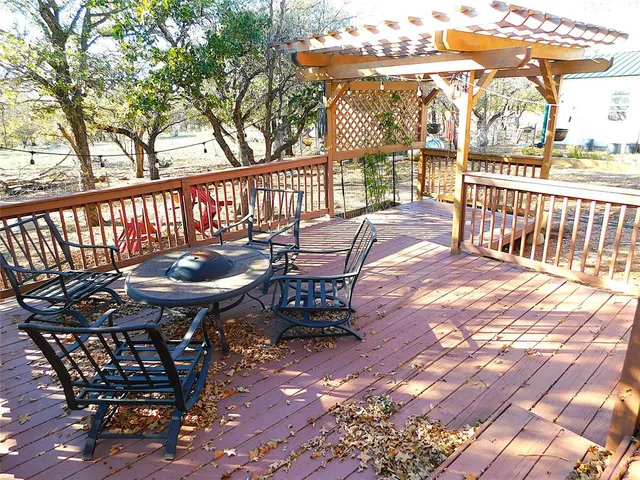 a view of a wooden house with a large tree